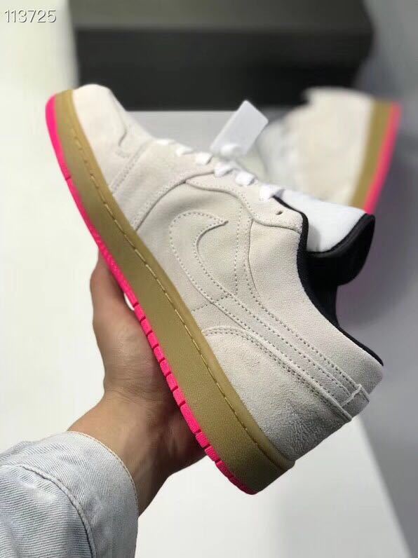 Side view highlighting the gray upper, stitched side detailing, gum-colored midsole, and pink outsole.