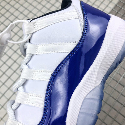 Close-up of white laces, white upper panels, and glossy blue overlay stitching.