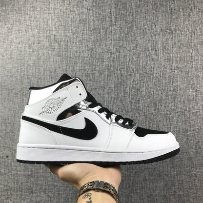 Side view of a white, black, and metallic silver Jordan mid-top sneaker.