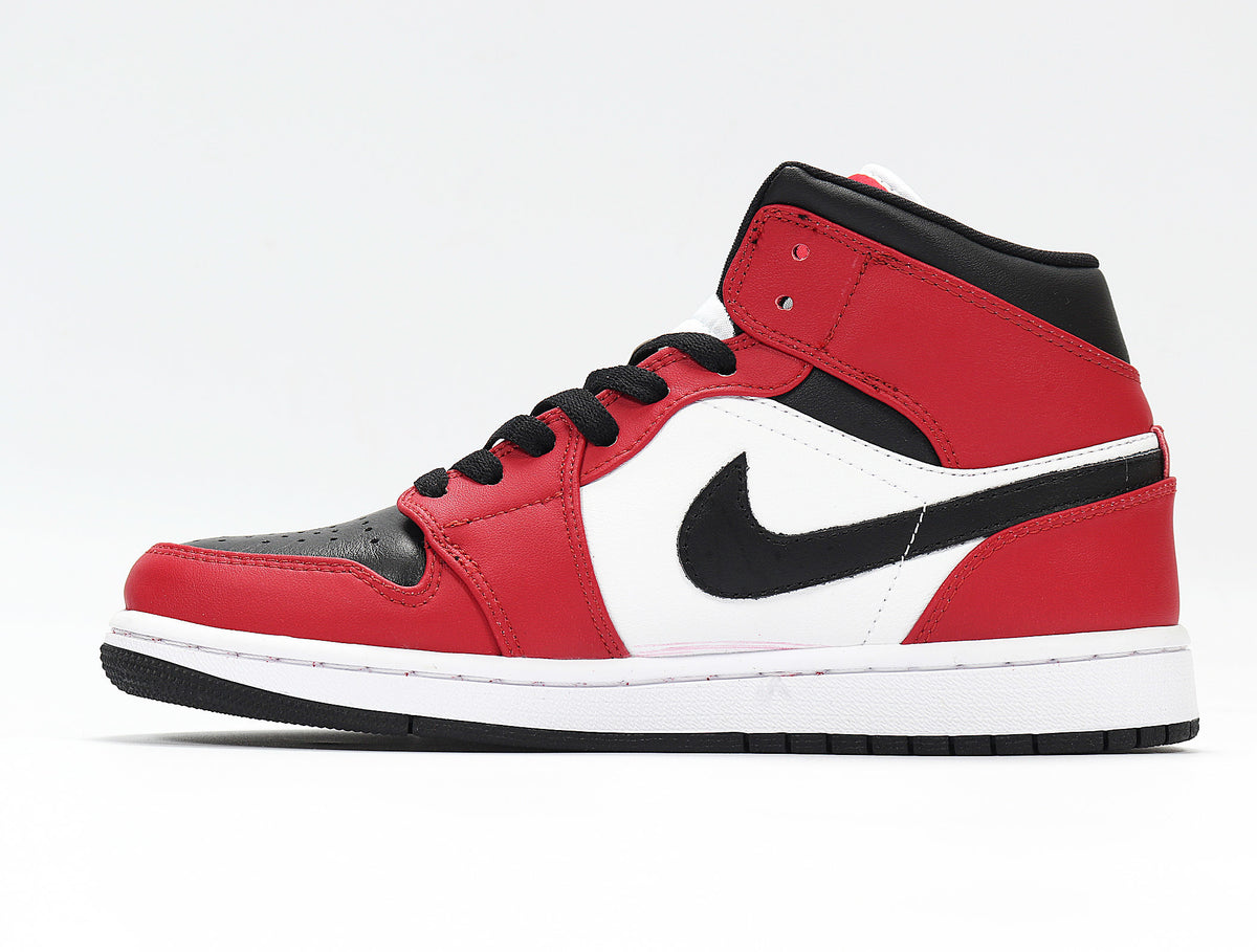 Side profile showing the red, black, and white upper, side emblem, white midsole, and black outsole