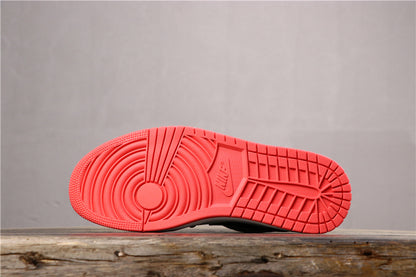 Underside view showing the bright red rubber outsole and its circular and grid traction pattern.