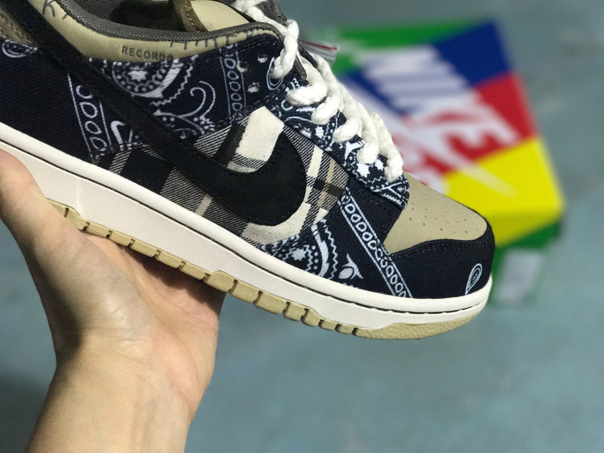 Close three-quarter view of the toe box, patterned overlays, dark Swoosh, and textured outsole.