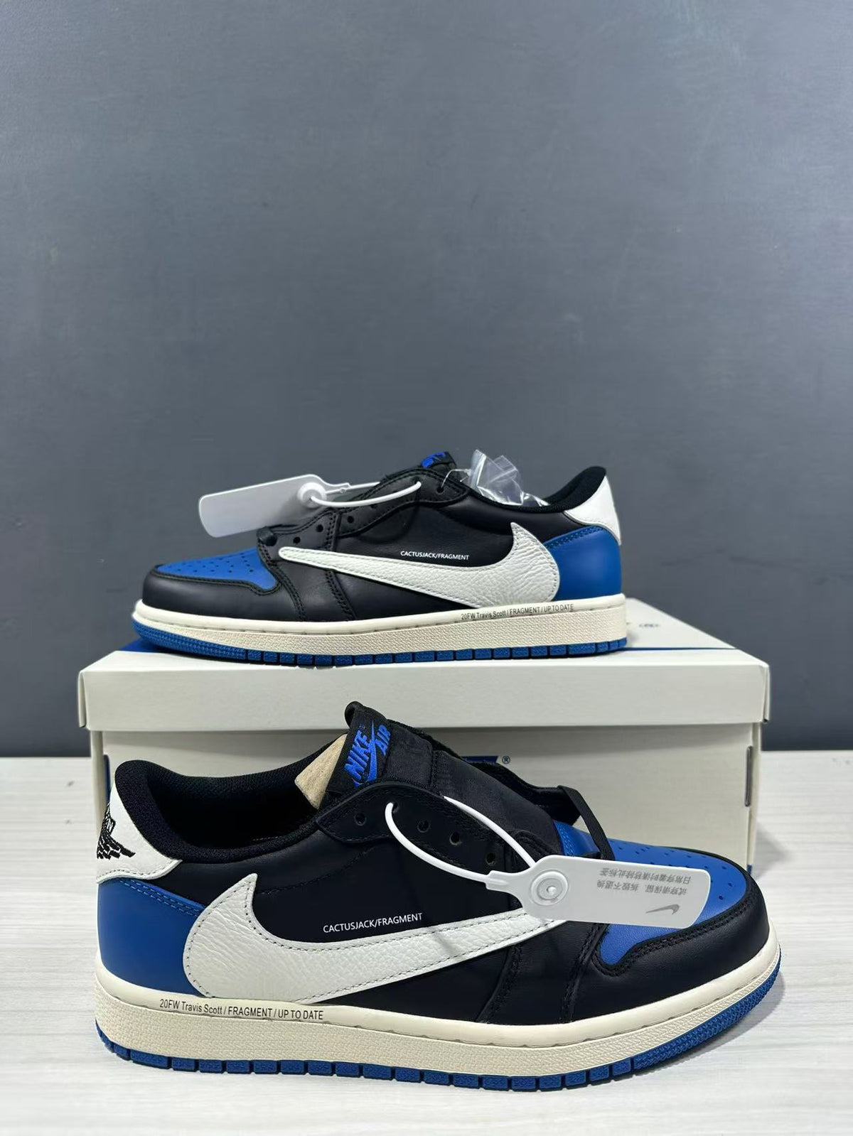 Close side view highlighting the white Swoosh, black panels, blue heel, and printed midsole detail.