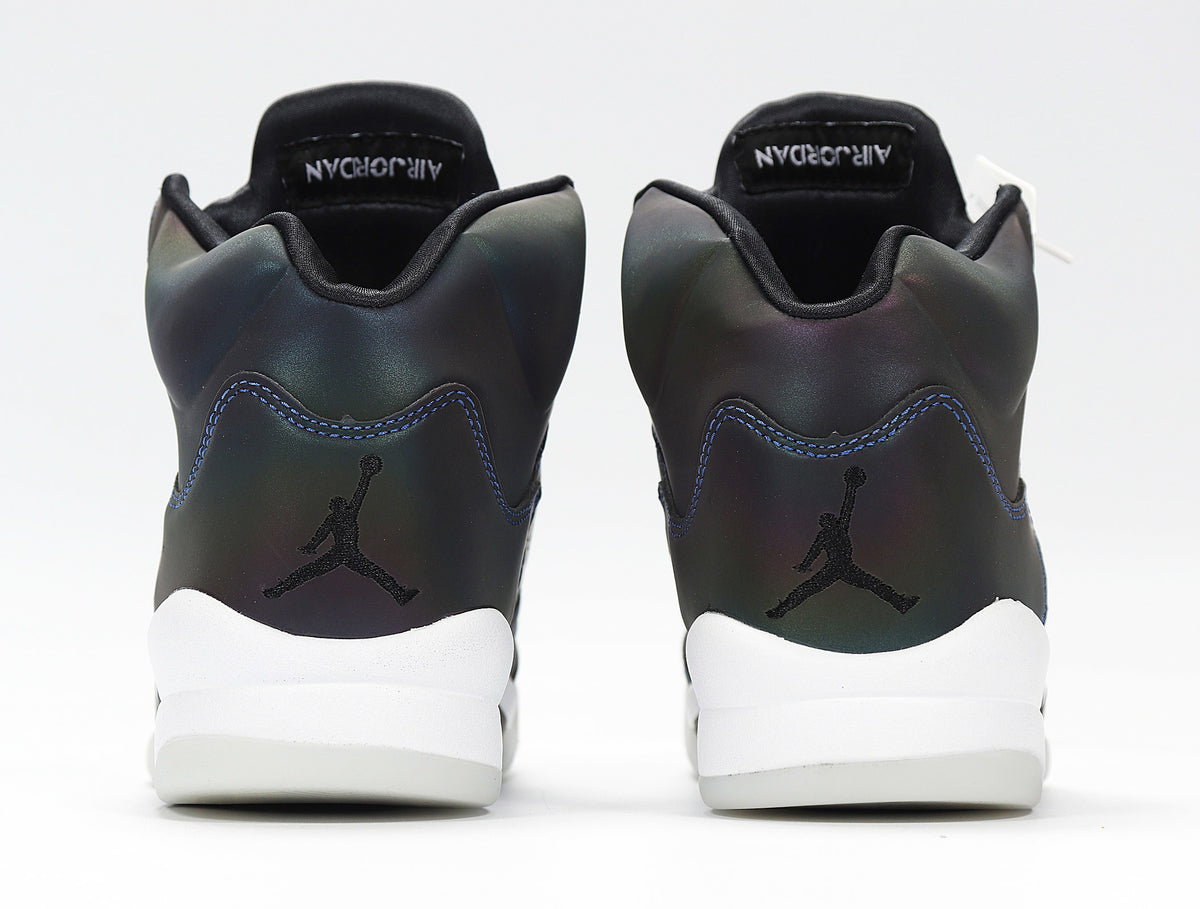 Rear view showing the heels and white midsoles of the sneakers.