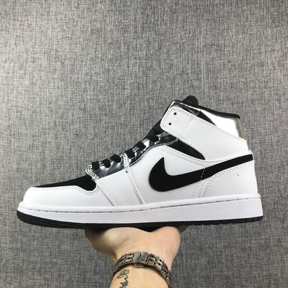 Opposite side view showing the black Swoosh, white panels, and metallic silver eyelet area.
