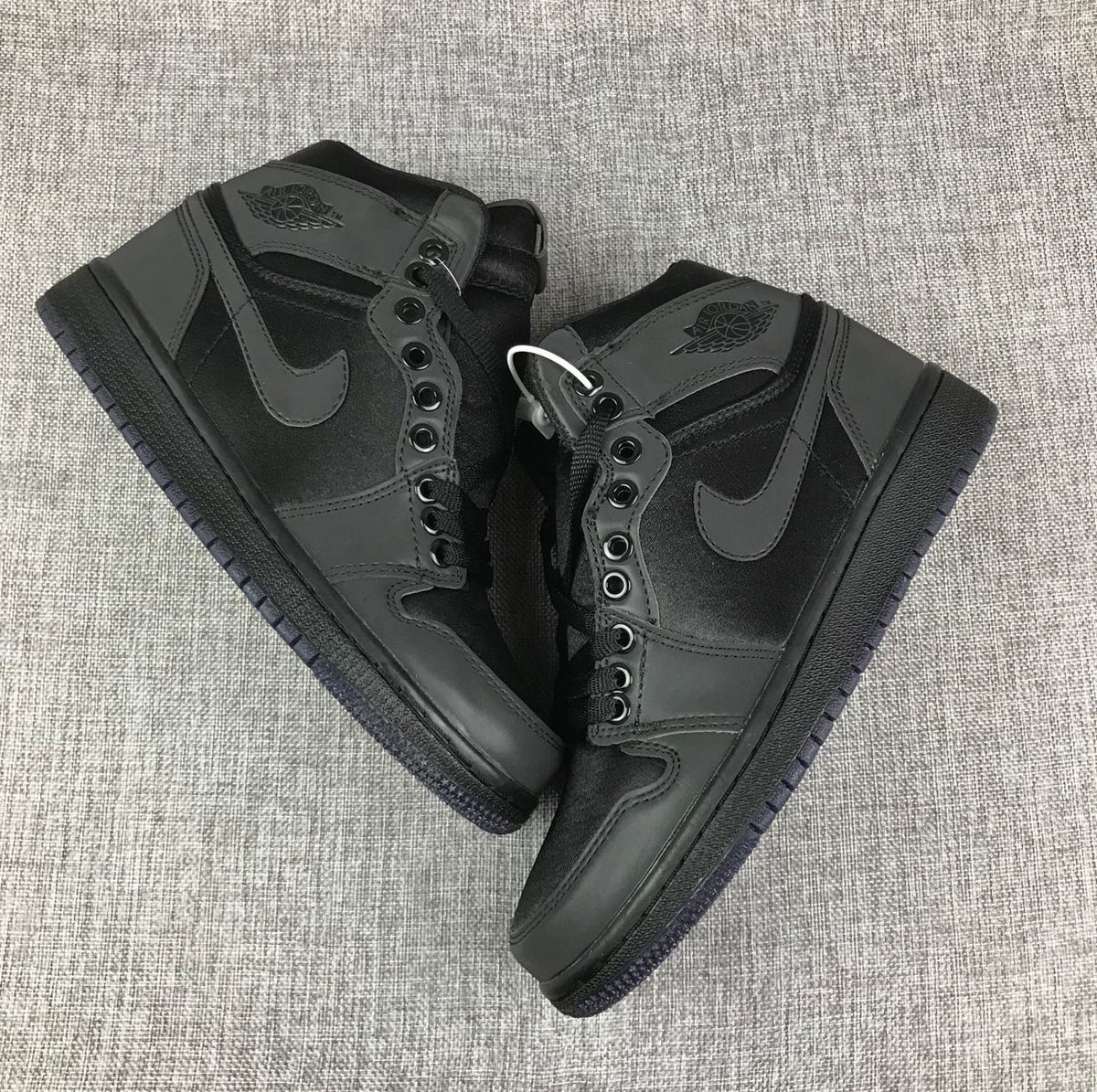 Top-down view of the pair showing the black high-top construction, laces, and tonal overlays.