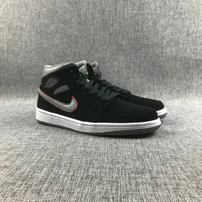 Pair of black and grey Air Jordan 1 Mid sneakers shown from a front three-quarter angle.