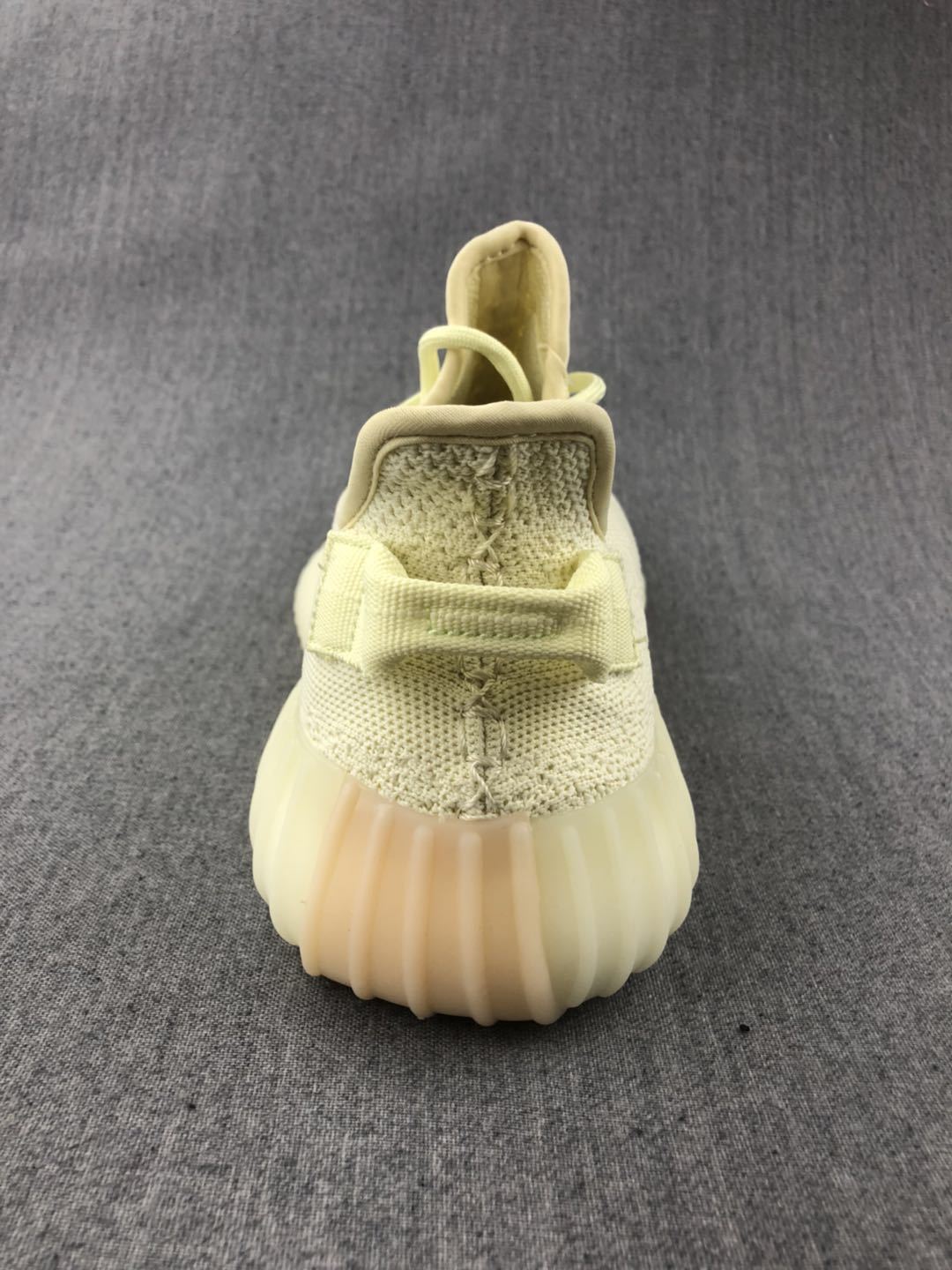 Rear view showing the padded collar, heel pull tab and translucent ribbed outsole.