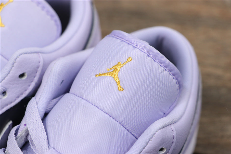 Close-up of the light purple padded tongue with embroidered gold Jordan branding.