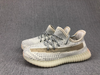 Angled pair view showing the matching cream-white and gray knitted uppers and translucent soles.