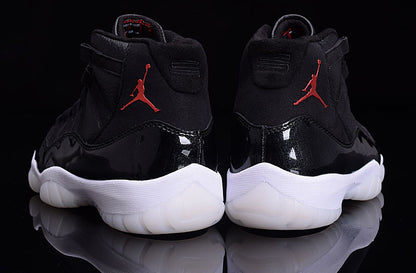 Rear view of the pair showing red heel branding, black uppers, and white translucent outsoles.