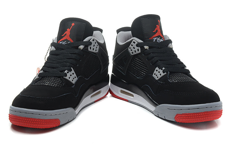 Front view of the pair showing black laces, mesh panels and red outsole sections.