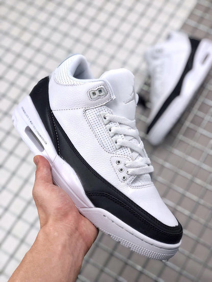 Front three-quarter view showing the white toe box, black mudguard, and lace system.