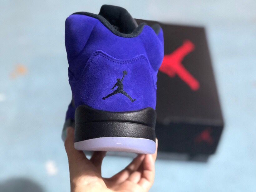 Rear view of the sneaker showing the black Jordan logo on the purple heel and translucent outsole.