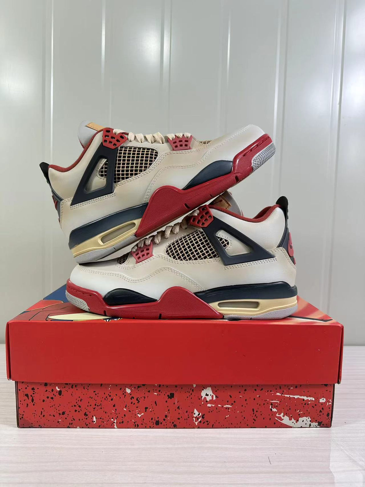 Two Jordan Air Jordan 4 Retro sneakers shown from opposite side angles with mesh panels and contrasting midsoles.