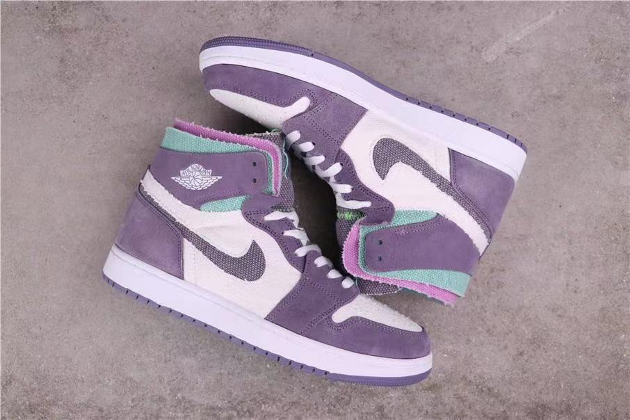 Sneakers arranged to show the lateral sides, lavender overlays, white panels and contrasting soles.