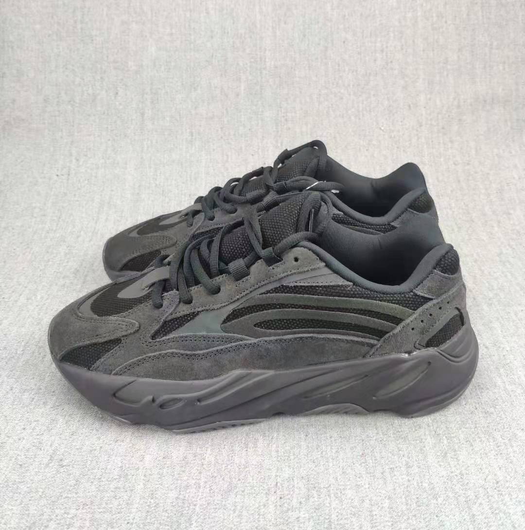 Pair of charcoal and gray lace-up sneakers shown from a three-quarter angle.
