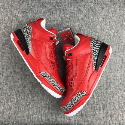 Pair of red Air Jordan 3 sneakers shown from above at an angle.