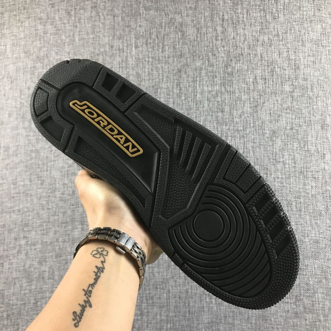 Black outsole with Jordan branding in a gold-colored inset