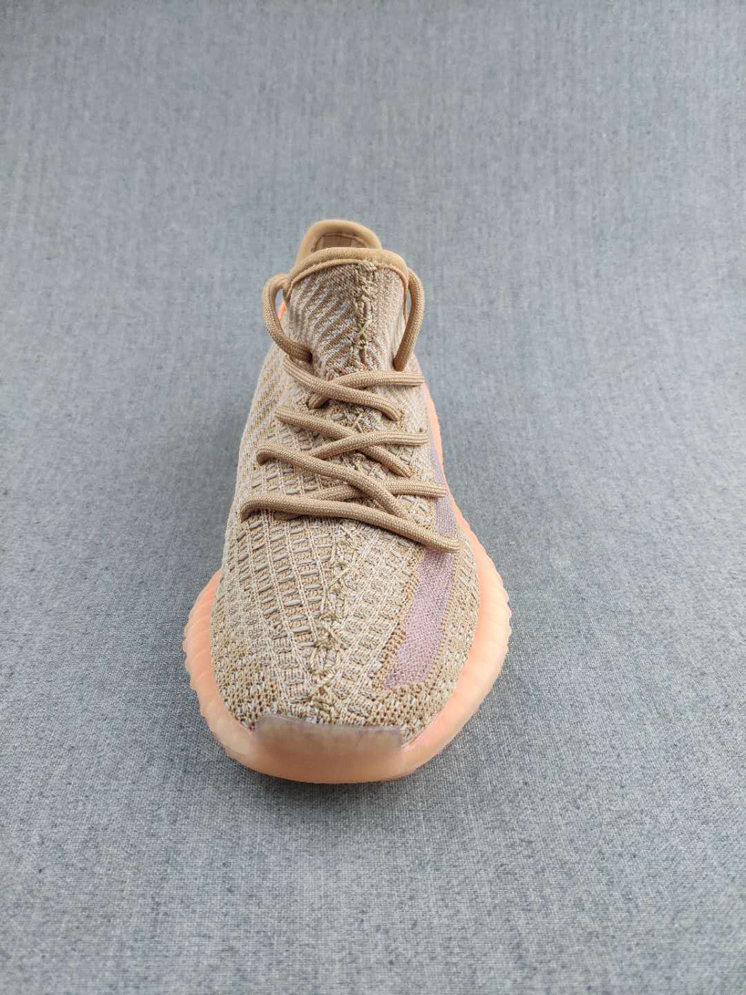Top-front view showing the textured tan upper, tonal laces, and mauve side stripe.