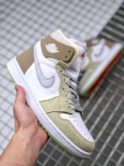 Three-quarter view of the sneaker showing the white perforated toe box, olive green overlays, gray laces, and brown ankle panel.