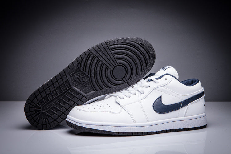 White Jordan sneakers showing the dark rubber outsole and circular traction pattern.