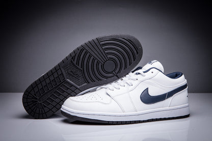 White Jordan sneakers showing the dark rubber outsole and circular traction pattern.