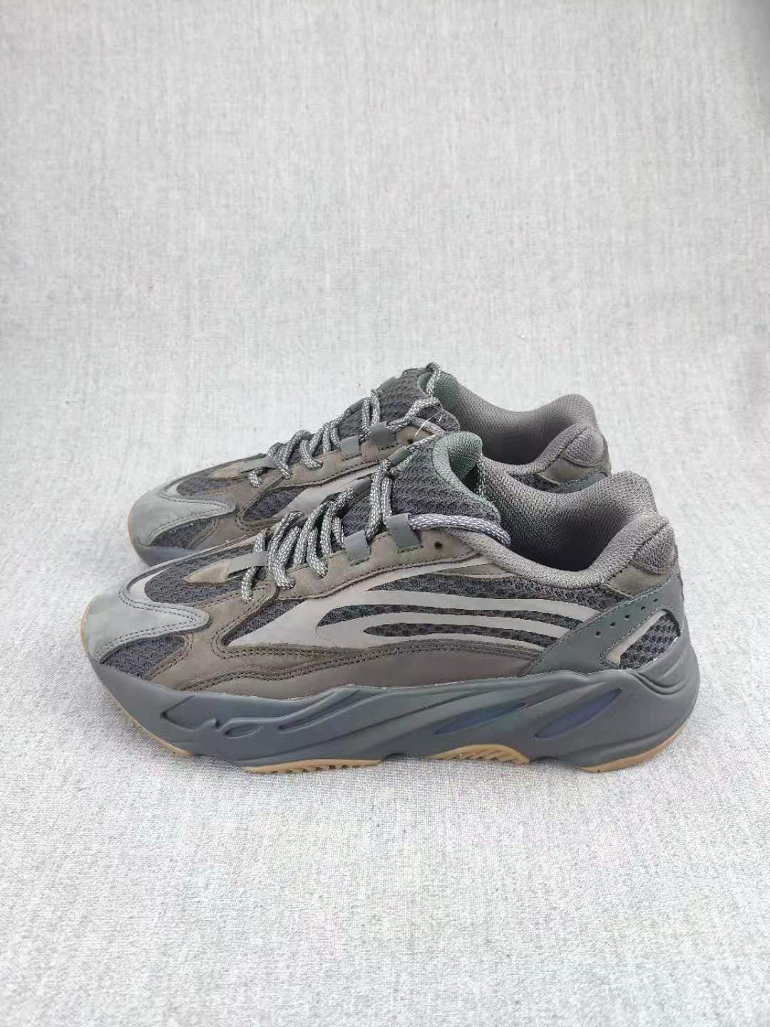 Pair of gray 700 V2-style sneakers shown at a three-quarter angle.
