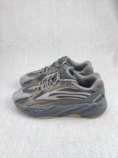 Pair of gray 700 V2-style sneakers shown at a three-quarter angle.