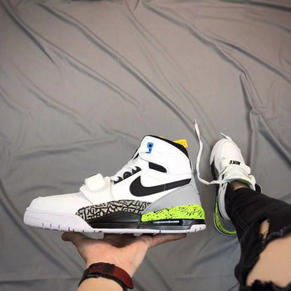 Side view of a white, black, gray, and bright green Air Jordan Legacy 312 sneaker