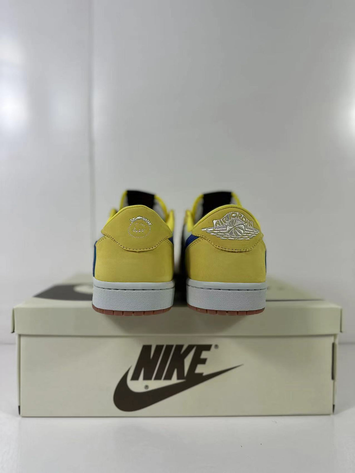 Rear view showing yellow heel panels and Air Jordan wing branding.