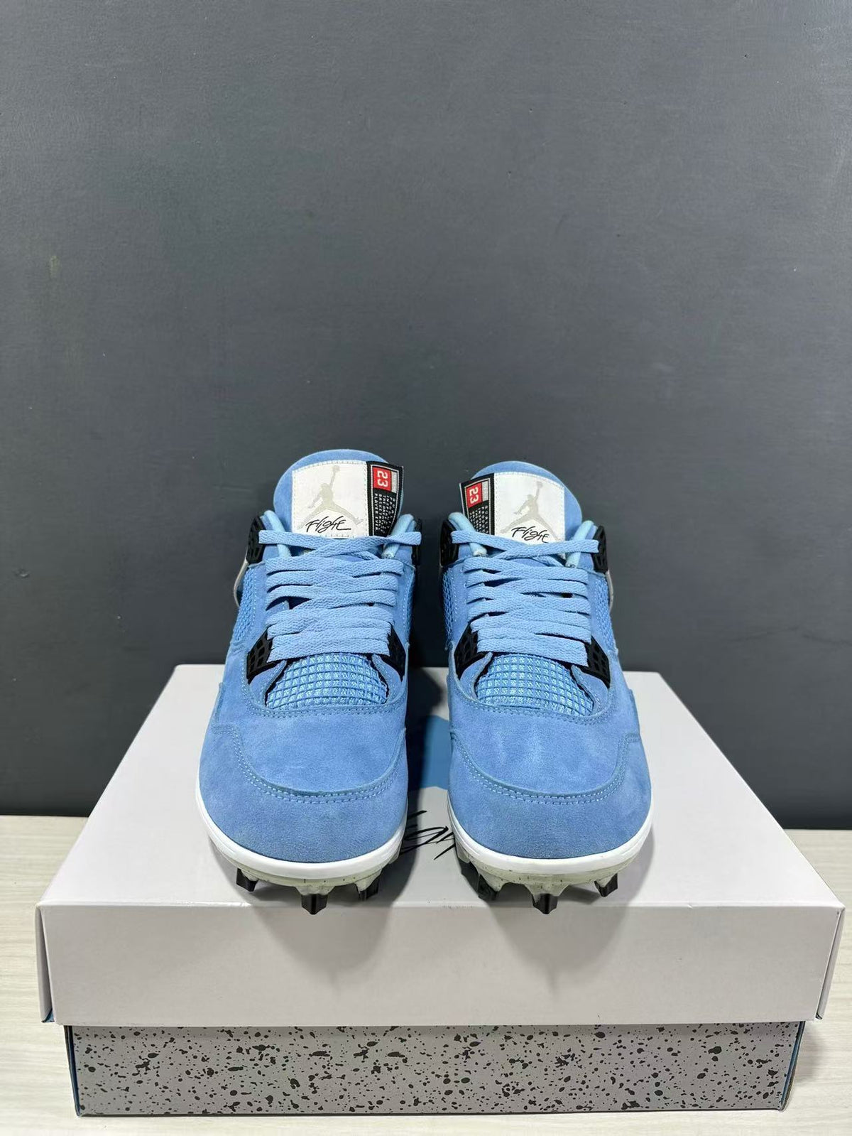 Front view of the paired blue high-top sneakers showing the laces, tongues, and mesh toe panels.