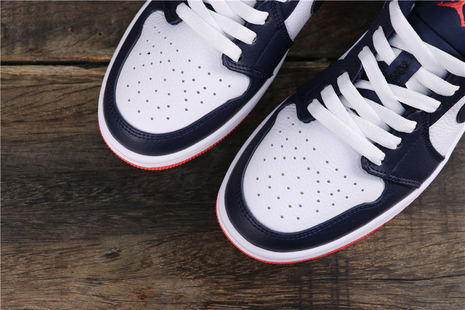Close-up of the white perforated toe boxes, dark blue overlays, white laces, and red outsole edges.