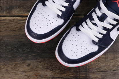 Close-up of the white perforated toe boxes, dark blue overlays, white laces, and red outsole edges.