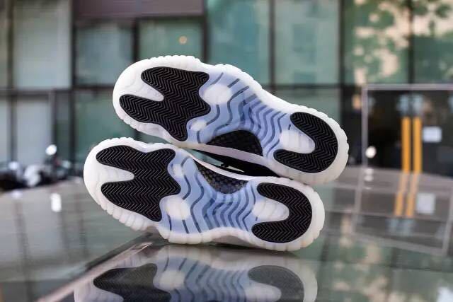 Outsole lifestyle view showing translucent rubber and black traction sections on both sneakers.
