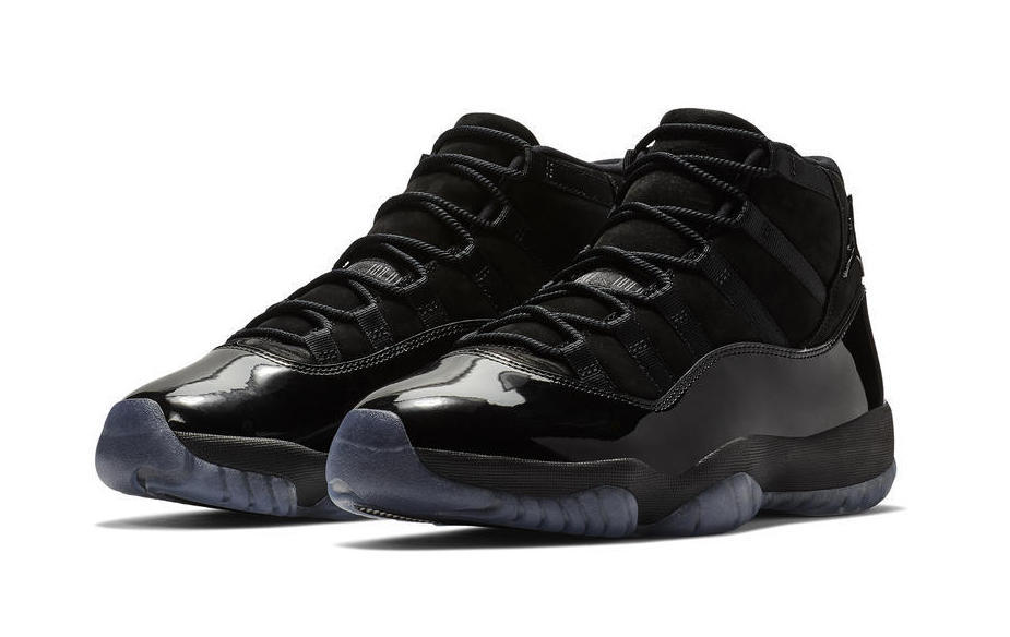 Studio three-quarter view of a pair of black high-top sneakers.