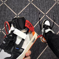 Close-up of the collar, strap, black overlays, and printed quotation on the midsole.