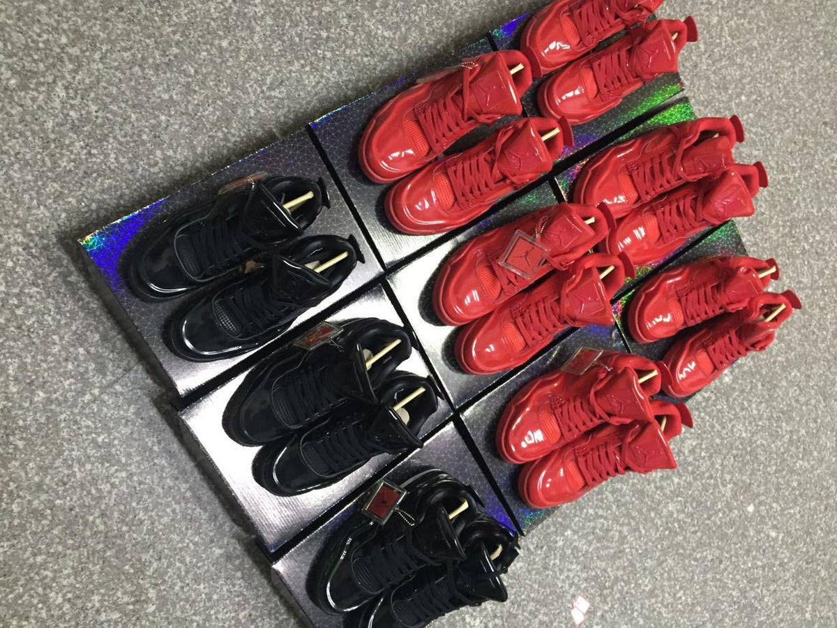 Angled group view of red and black high-top sneakers displayed on patterned boxes.