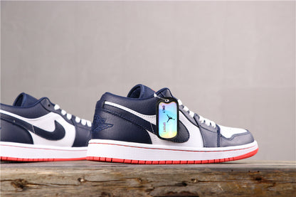 Side profile of the low-top sneakers showing the dark blue and white color blocking, white midsole, and red outsole.