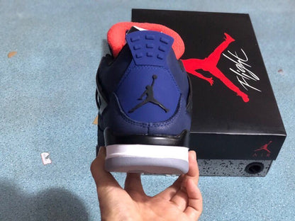 Heel view of a blue sneaker with a Jumpman emblem and white and gray sole
