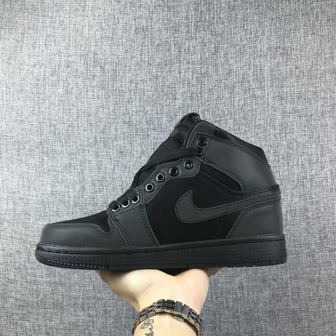 Side profile of a black high-top sneaker showing the tonal side logo and layered panels.