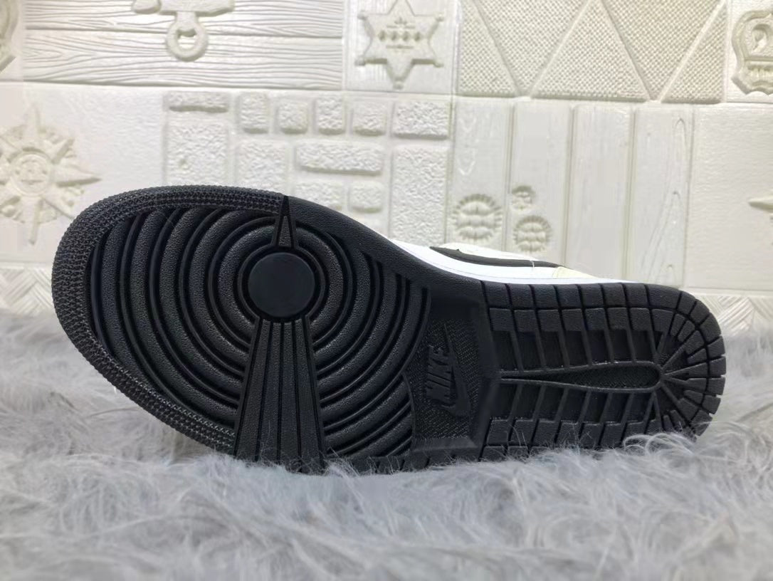 Underside view showing the black rubber outsole with circular forefoot grooves and segmented traction blocks.