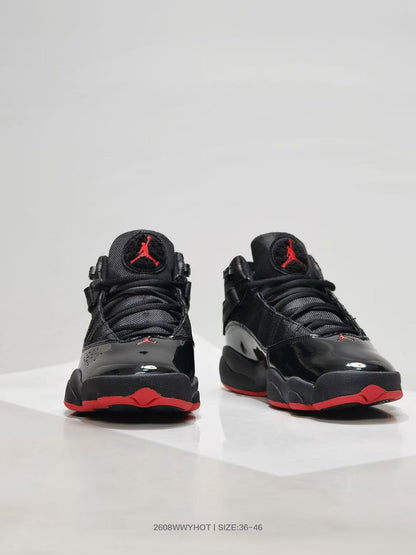 Front view of black high-top sneakers with red outsole accents and Jordan tongue logos.