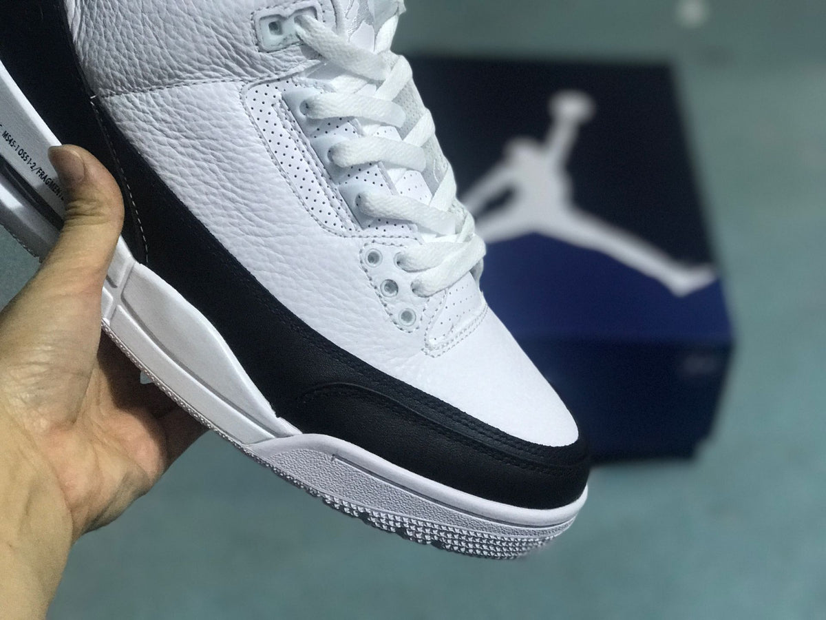 Close-up of the sneaker’s perforated panels, laces, and black toe overlay.