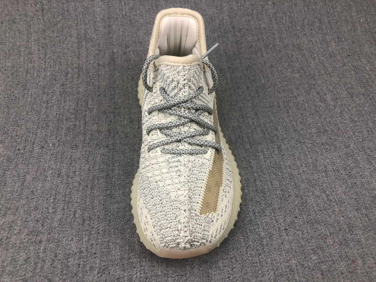 Top view showing the gray-and-white laces, knitted tongue area, and rounded toe.