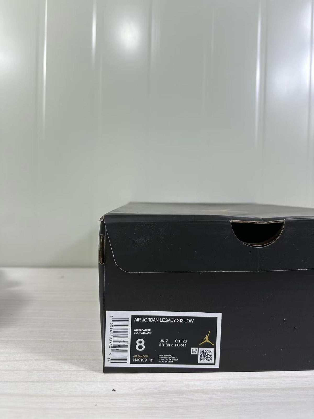 Black shoe box label showing Air Jordan Legacy 312 Low, white/white color, style code HJ9199 111, and sample size 8.