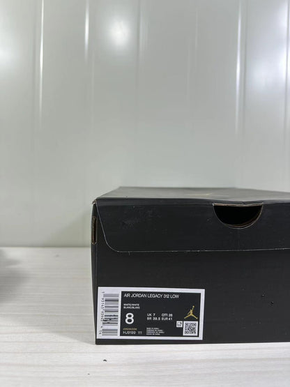 Black shoe box label showing Air Jordan Legacy 312 Low, white/white color, style code HJ9199 111, and sample size 8.