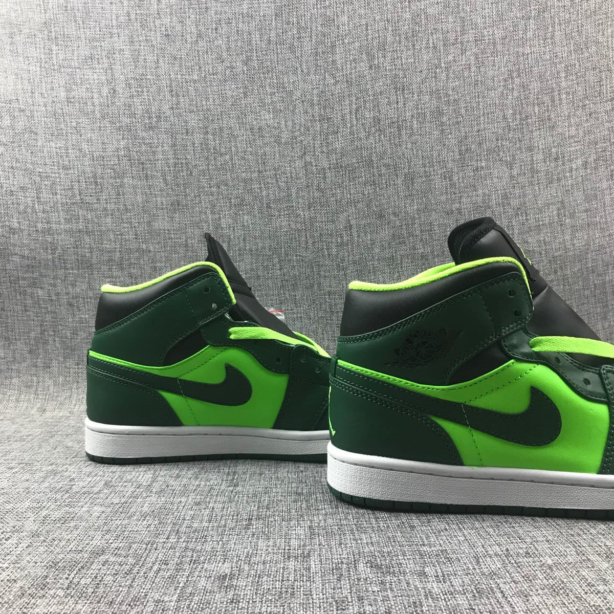 Side view of both sneakers showing the ankle panels, Swoosh details, and contrasting color blocking.
