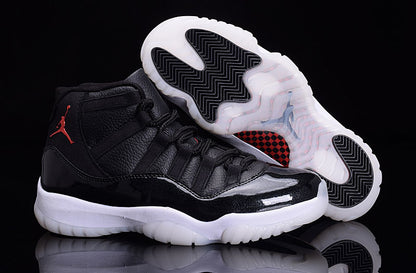 Black and white sneakers displayed with one outsole facing upward, showing black traction sections and a translucent sole.