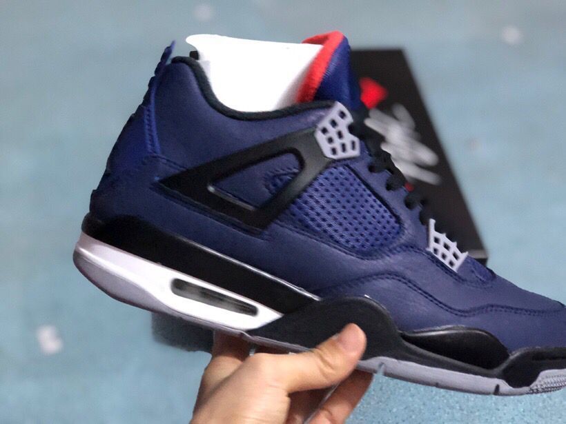 Side view of a dark blue sneaker with perforated panels and a visible air unit
